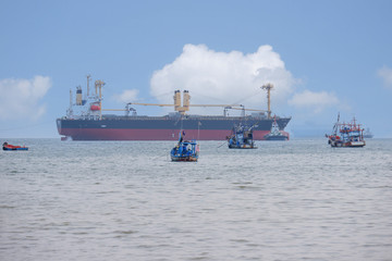 Large vessels carrying goods through fishing vessels