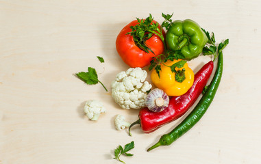 Fototapeta na wymiar Top view tomato with peppers, cauliflower, greens, chili peppers on white background. horizontal