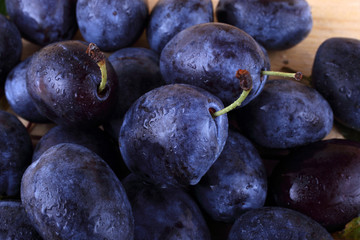 Blue plums on table