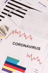 Inscription coronavirus, dollars and downward graphs representing financial crisis caused by Covid-19. Risk of recession around world