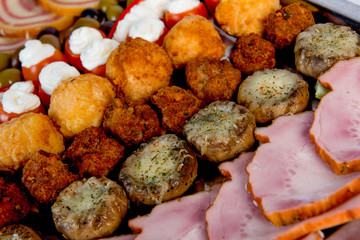 plate with meat, meatballs, vegetables, cheese, spices and bread
