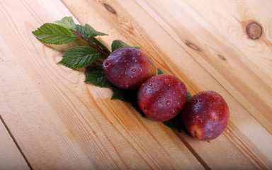 Red plums on table