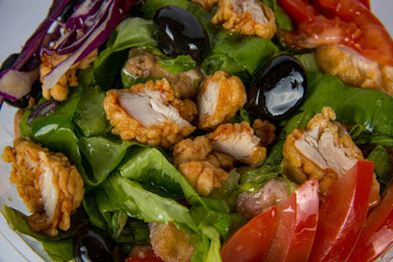 bowl with salad and vegetables seasoned with sauces
