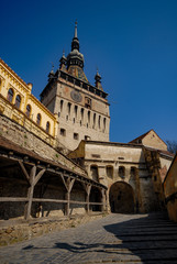 Fototapeta premium the clock tower in Sighisoara and the cobbled alley