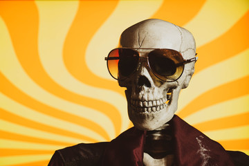 A skeleton dressed in a 1970's era collared shirt and vest, with sunglasses. White cocaine powder...