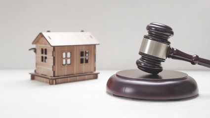 House model with a judge gavel.