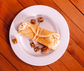 pancakes on a plate  blinches - thin pancakes with cottage cheese and raisins filling