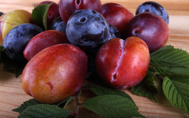 Different color plums on table