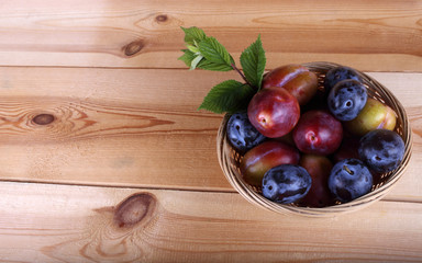 Different color plums on table
