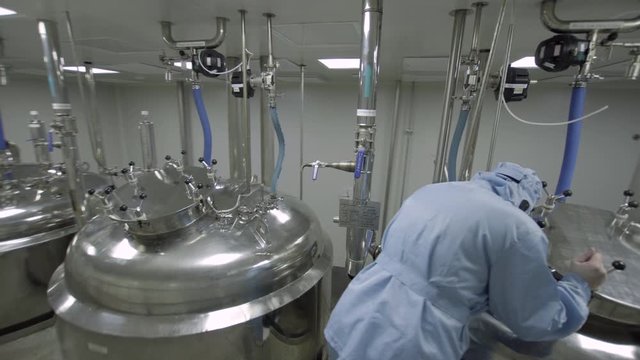 operator monitoring production of medical solutions medical industry