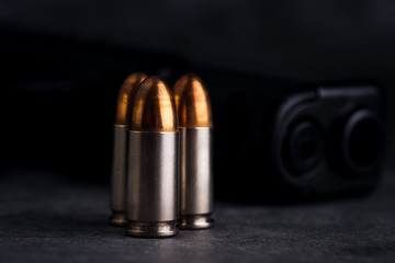 Bullet 9mm. On the dark stone table.rounds and military technology.