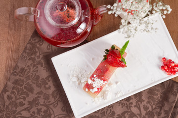 Jelly dessert with strawberries on white plate