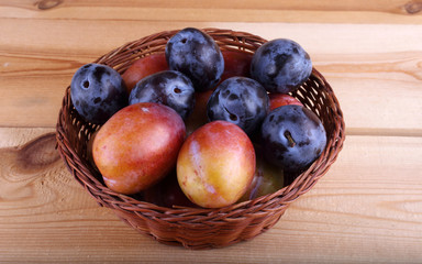 Different color plums on table