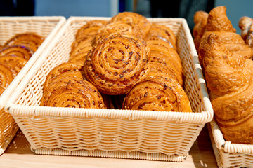 A variety of sweet buns and croissants.
