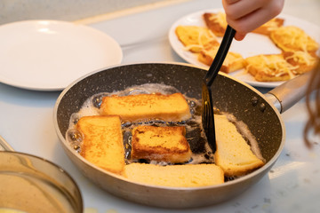 toast with egg in a frying pan fry hands kid girl