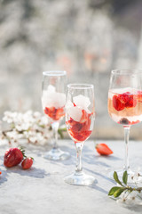 Pink cocktail with champagne or prosecco and fresh raspberries for St. Valentine's day.