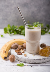 Healthy breakfast. Banana walnuts smoothie with collagen, coconut milk in glass jar
