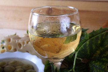 Wine, grape, cheese, bread and olives on table