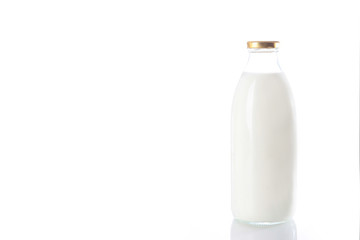 Glass bottle with milk on a white background. An isolated object. Copy of the space.