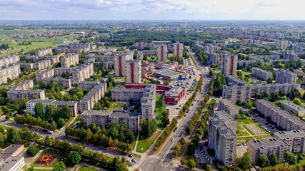 Aerial panoramic view of the southern part of Siauliai city in Lithuania.Old soviet union buildings with green naturearound and yards full of cars in a sunny day.
