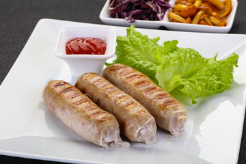 Grilled sausages served mushrooms and cabbage