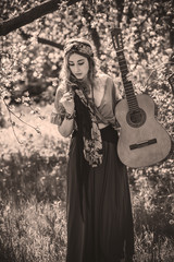 Gypsy woman with guitar at field, lifestyle, ideas for costume on Halloween