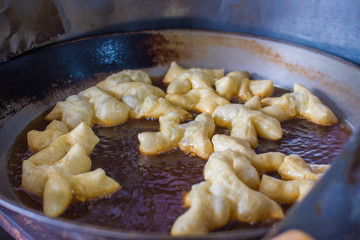 Crispy batter in a pan of oil is boiled as Asian desserts eaten with condensed milk or jam.