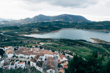 Fototapeta na wymiar Old town in spanish andalusia mountains, view on lake from top, white houses Zahara-de-la-Sierra