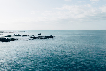 Blue ocean view with rocks, daylight