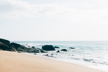 Ocean seasade with waves, sand and rocks 