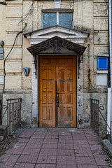entrance to the old building. Doorway of stone house facade. Architecture of European city. Vintage building exterior.