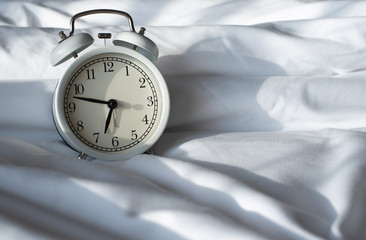 Alarm clock on bed
