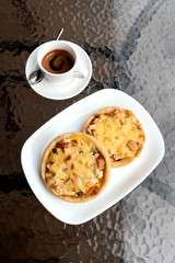 Bakery, pie with kiwi and apple, espresso coffee on cafe table.
