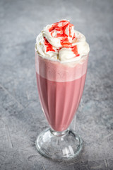 Cherry Milkshake in a transparent, tall, glass glass