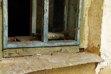 old wine bottle in a broken window