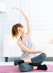 Young woman practicing yoga at home in the living room