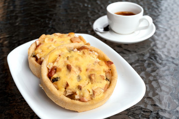 Bakery, pie with kiwi and apple, espresso coffee on cafe table.