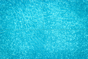 Fototapeta premium Abstract top view blue swimming pool water and reflection.