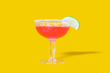 Strawberry daiquiri with lime in saucer champagne.