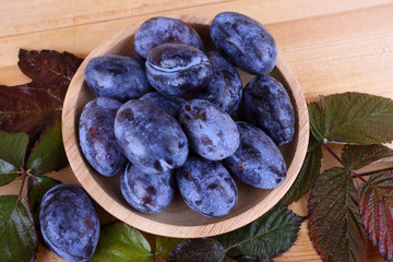 Black plums on table