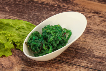 Green Chuka Seaweed Salad Isolated on White Background Top View. Wakame Sea Kelp Salat