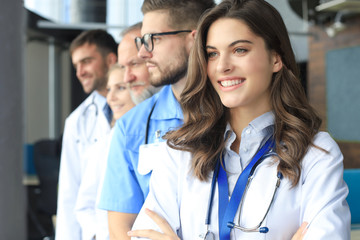Female doctor with group of happy successful colleagues.