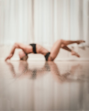 young woman doing a stretch in the gym