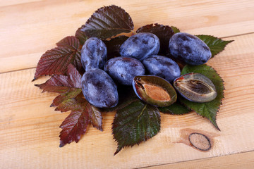 Blue plums on table