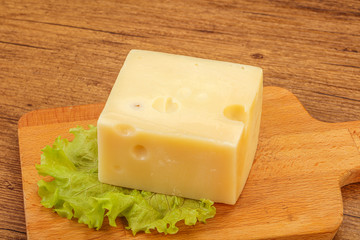 Emmental cheese over wooden board