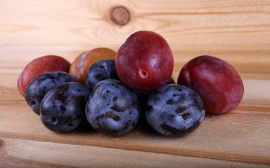 Different color plums on table