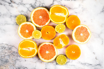 Citrus fruit, cut into slices on a marble background