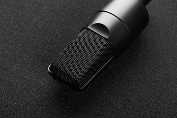 Modern professional microphone on a black background