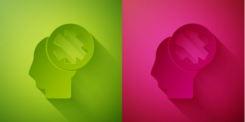 Paper cut Male head with hospital icon isolated on green and pink background. Head with mental health, healthcare and medical sign. Paper art style. Vector Illustration