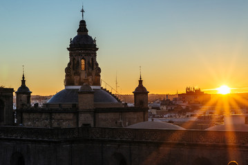 Fototapeta na wymiar Sunset in Seville with orange rays illuminating the city.